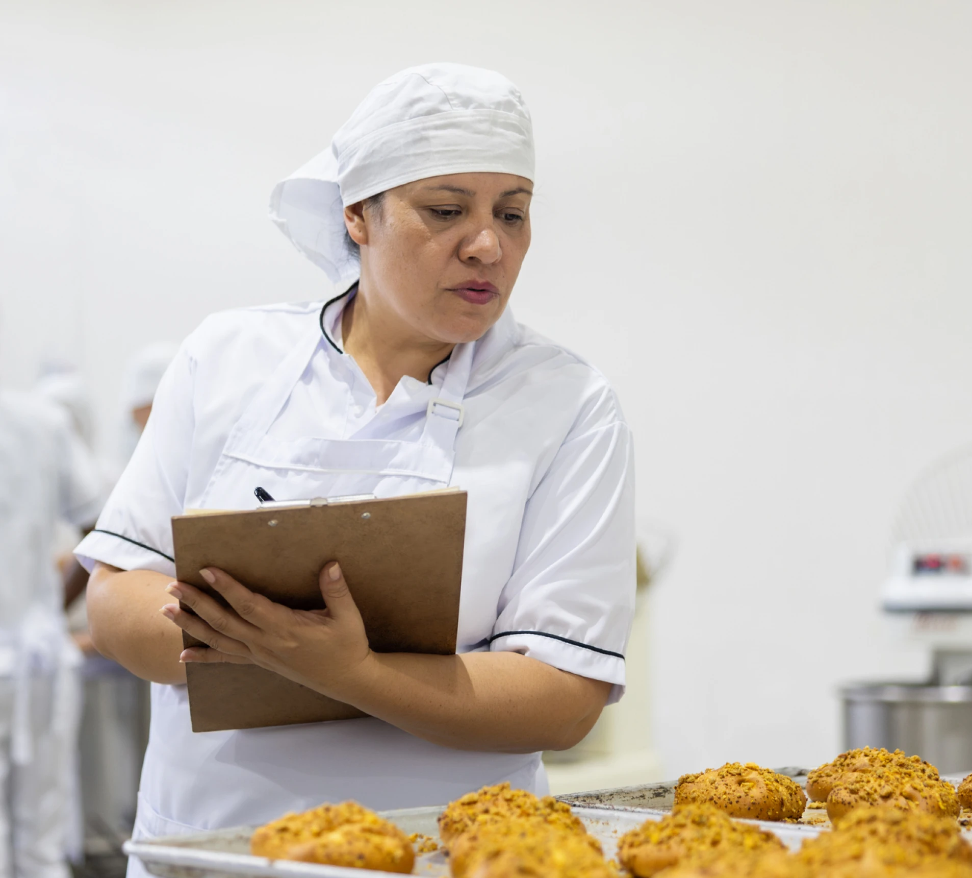 Baker inspecting freshly baked bread