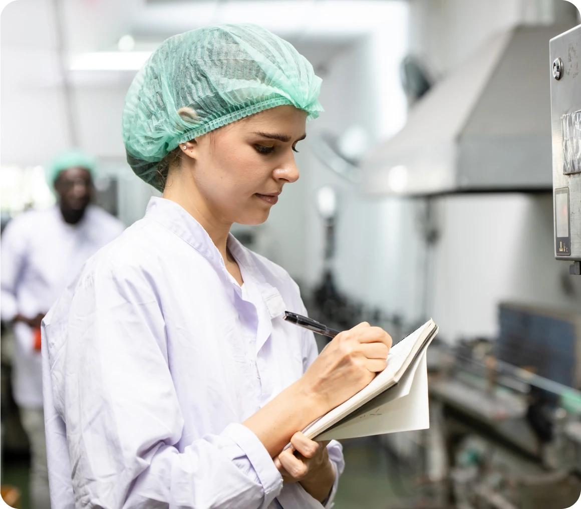 Factory worker taking notes